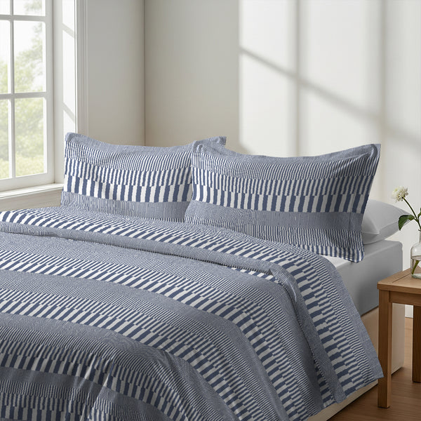 Calm luxurious bedroom bed with Cascade Stripe Blue Pizuna Linens cotton duvet cover double size