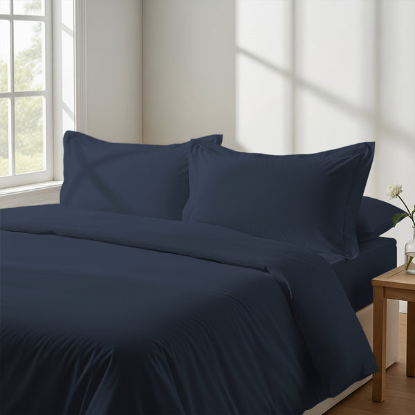 Calm luxurious bedroom bed with Dark blue Pizuna Linens cotton duvet cover emperor size