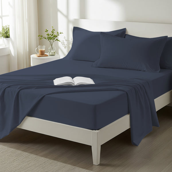 Bed styled in a bedroom with percale cotton Dark Blue 4 piece king size sheet set
