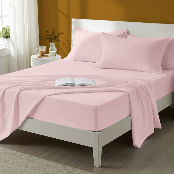 Bed styled in a bedroom with percale cotton Light Pink 4 piece king size sheet set