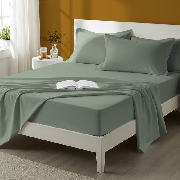 Bed styled in a bedroom with percale cotton Sea Foam 4 piece king size sheet set