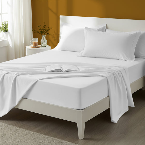 Bed styled in a bedroom with percale cotton white 4 piece king size sheet set