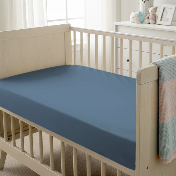 Baby cot setup with 40x90cm Dusty Blue cot fitted sheet moisture wicking and gentle on skin