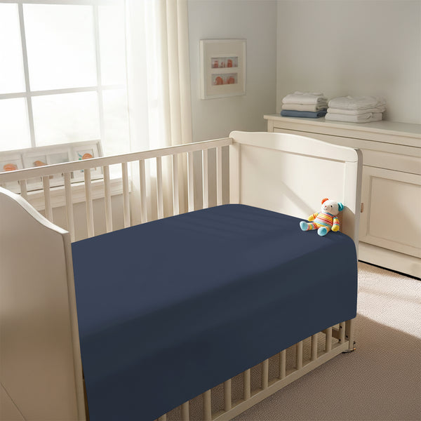 Peaceful nursery scene showing a crib with a dark blue cotton crib flat sheet 120×150 cm