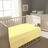 Peaceful nursery scene showing a crib with a mellow yellow cotton crib flat sheet 120×150 cm