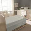 Peaceful nursery scene showing a crib with a silver cotton crib flat sheet 70×100 cm