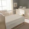 Peaceful nursery scene showing a crib with a simply taupe cotton crib flat sheet 120×150 cm