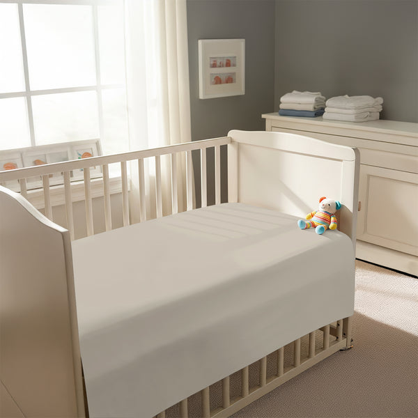 Peaceful nursery scene showing a crib with a simply taupe cotton crib flat sheet 120×150 cm