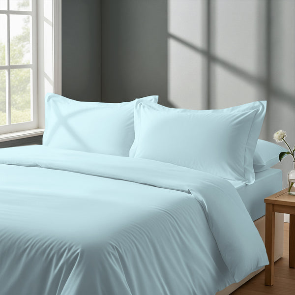 Bedroom with bed dressed in royal 1000 thread count baby blue double duvet cover with Oxford pillowcases