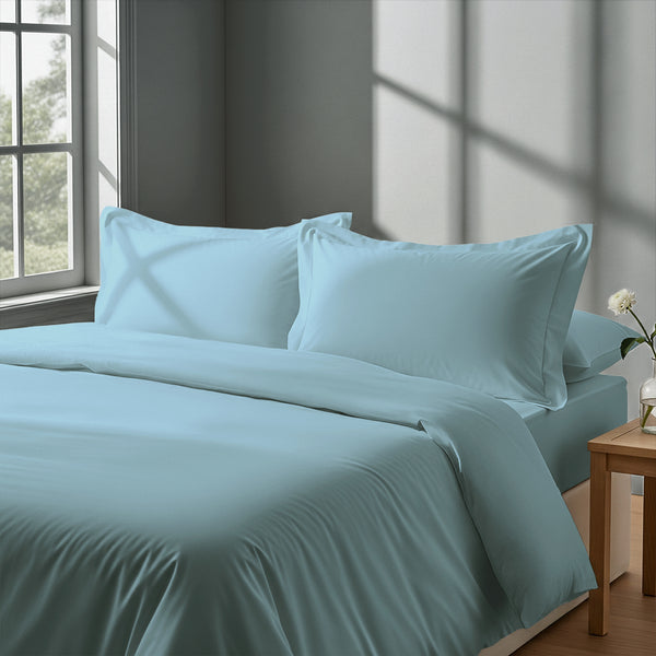 Bedroom with 3 piece 600 thread count baby blue king duvet cover and pillowcases on the bed