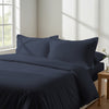 Bedroom with 3 piece 600 thread count dark blue king duvet cover and pillowcases on the bed