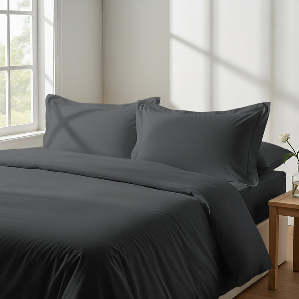 Bedroom with 3 piece 600 thread count dark grey king duvet cover and pillowcases on the bed