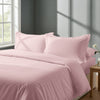 Bed in a bedroom dressed with percale cotton duvet cover light pink double 3 piece