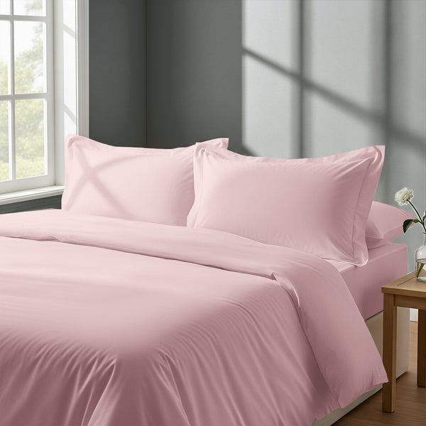 Bed in a bedroom dressed with percale cotton duvet cover light pink single 2 piece