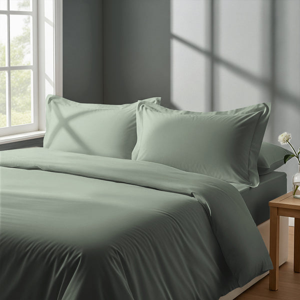 Bed in a bedroom dressed with percale cotton duvet cover Sea Foam king 3 piece