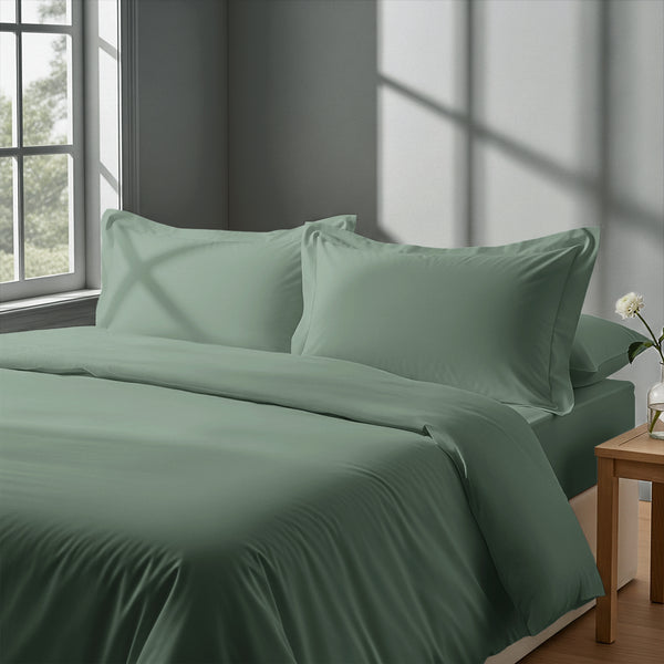 Bedroom with 3 piece 600 thread count sea foam king duvet cover and pillowcases on the bed