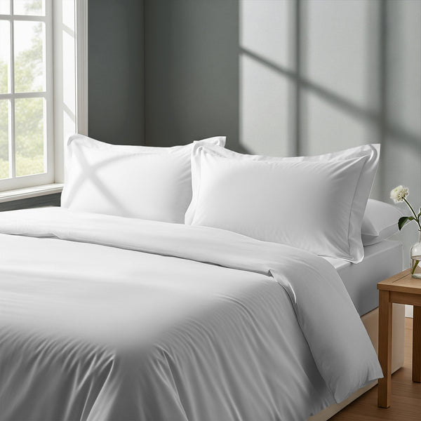 Bed in a bedroom dressed with percale cotton duvet cover White king 3 piece