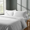 Bedroom with bed dressed in royal 1000 thread count white double duvet cover with Oxford pillowcases