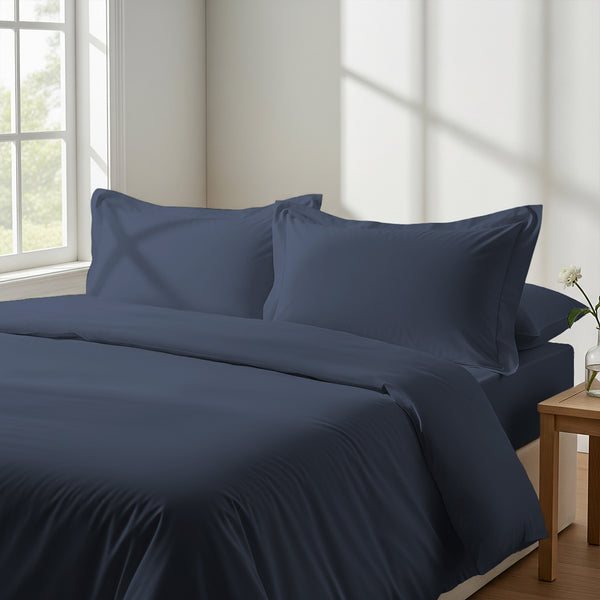 Bed in bedroom dressed with luxurious Dark Blue king 800 thread count duvet cover 3 piece and pillowcases