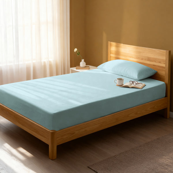 Bed in a bedroom dressed with 400 thread count baby blue single cotton fitted sheet