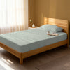 Bed in a bedroom dressed with 400 thread count cascade stripe green small single cotton fitted sheet