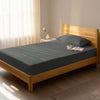 Bed in a bedroom dressed with 400 thread count dark grey small single cotton fitted sheet
