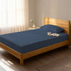 Bed in bedroom dressed with luxurious 1000 thread count dark blue eu single