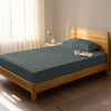 Bed in bedroom dressed with luxurious 1000 thread count dark grey Single