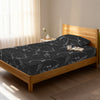 Bed in a bedroom dressed with 400 thread count marble black single cotton fitted sheet