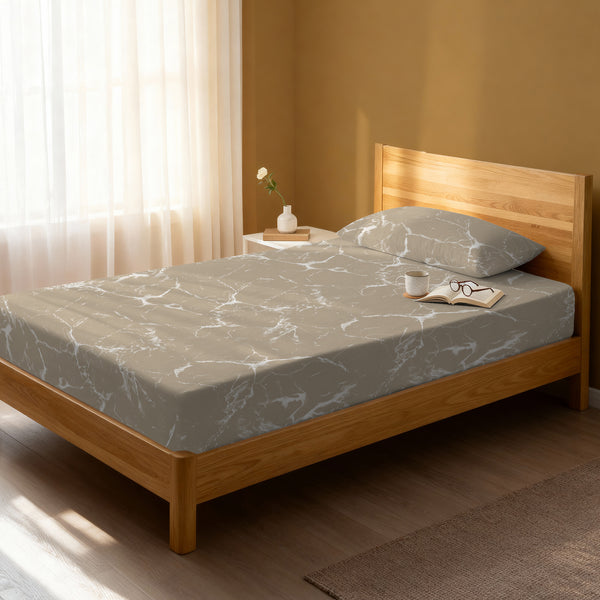 Bed in a bedroom dressed with 400 thread count marble taupe small single cotton fitted sheet