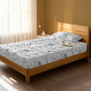 Bed in a bedroom dressed with 400 thread count marble white small single cotton fitted sheet