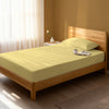 Bed in bedroom dressed with luxurious 1000 thread count mellow yellow Single