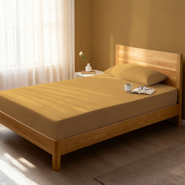Bed in a bedroom dressed with 400 thread count Mustard Yellow EU Single cotton fitted sheet