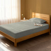 Bed in a bedroom dressed with 400 thread count white small single cotton fitted sheet
