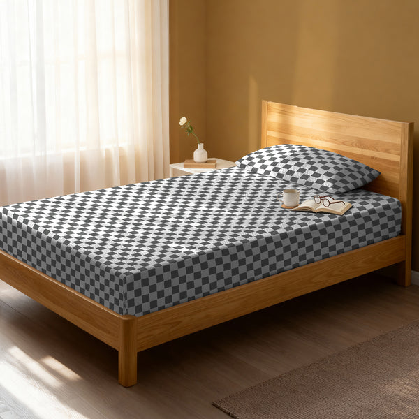 Bed in a bedroom dressed with 400 thread count smart checks grey small single cotton fitted sheet