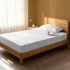 Bed in a bedroom dressed with 400 thread count white single cotton fitted sheet