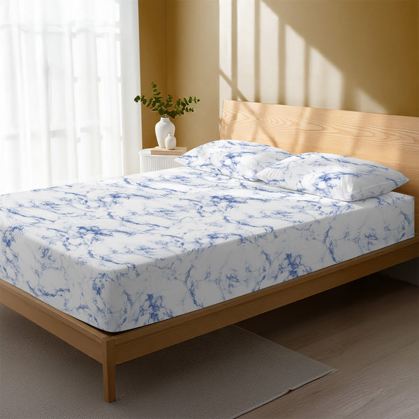 Bed in a bedroom dressed with 400 thread count Carrara Marble Blue small double cotton fitted sheet