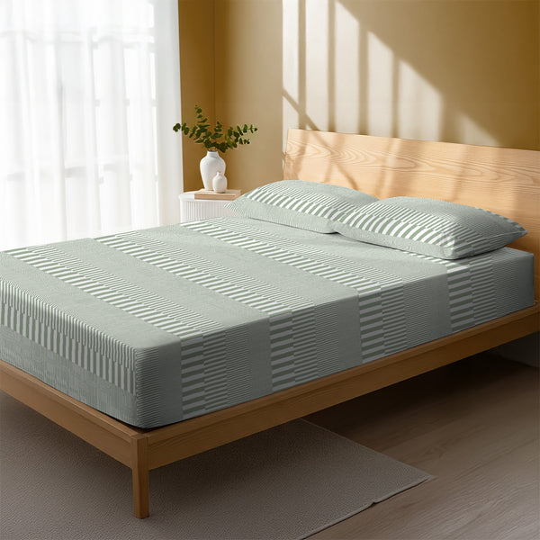 Bed in a bedroom dressed with 400 thread count Cascade Stripe Green super king cotton fitted sheet