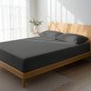 Bed in a bedroom dressed with 400 thread count dark grey double cotton fitted sheet