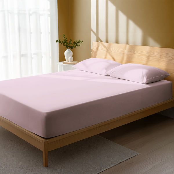 Bed in bedroom dressed with luxurious 1000 thread count light pink Super King