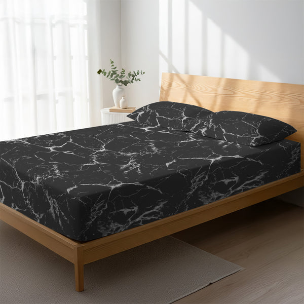 Bed in a bedroom dressed with 400 thread count Marble Black super king cotton fitted sheet