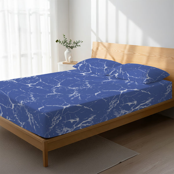 Bed in a bedroom dressed with 400 thread count Marble Blue small double cotton fitted sheet