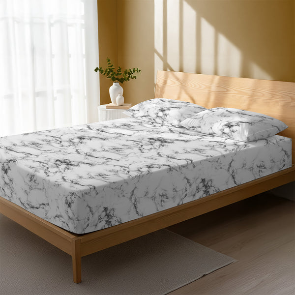 Bed in a bedroom dressed with 400 thread count Marble White king cotton fitted sheet