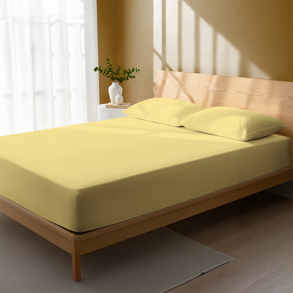 Bed in bedroom dressed with luxurious 1000 thread count mellow yellow King