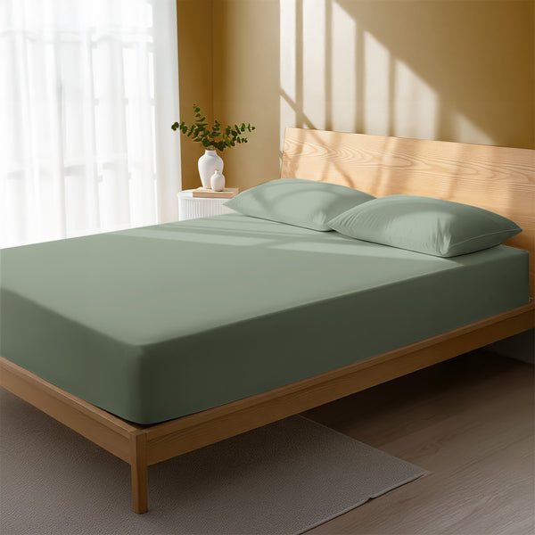 Bed in a bedroom dressed with 400 thread count sea foam king cotton fitted sheet