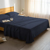 Bedroom bed dressed with premium cotton flat sheet dark blue double size 600 thread count
