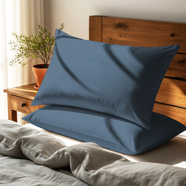 dusty blue housewife pillowcases premium 400 thread count on pillows on bed in bedroom