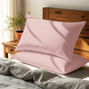 light pink housewife pillowcases premium 400 thread count on pillows on bed in bedroom