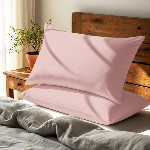 light pink housewife pillowcases premium 400 thread count on pillows on bed in bedroom