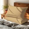 tan housewife pillowcases premium 400 thread count on pillows on bed in bedroom